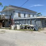 A burnt out, abandoned laundromat. Hide stash here.